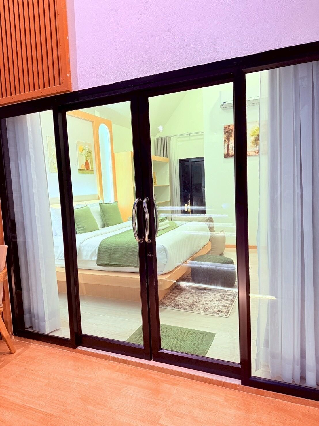 A bedroom with a bed, a desk, and a chair.