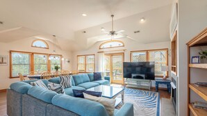 A spacious living room with a sectional sofa, a coffee table, a TV, and a fireplace. - Seventh Heaven - Corolla, Ocean Sands, 500 Yds to Beach, Pool, Hot Tub, Pool Table, Pets OK (Corolla)