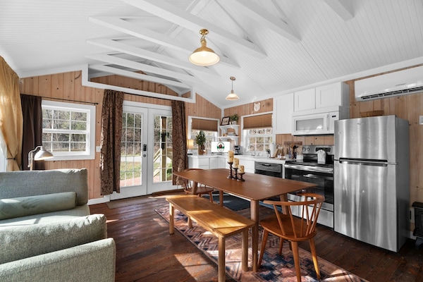 The open concept space features a fully equipped kitchen, along with a dining area and a living room