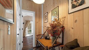 A wooden interior with a dining table, chairs, a radio, and a vase with dried flowers. - Creekside Cabin W/ Pool Access & Private Hot Tub Near Thunder Ridge • Sleeps 4 (Blue Eye)