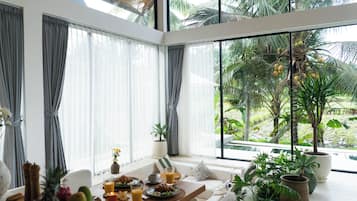 Deluxe Villa, Patio, Pool View | Living area