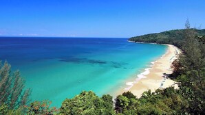 A coastal landscape with a sandy beach and clear turquoise waters. - Malaiwana - Duplex (A3) by Elite Havens (A. Thalang)