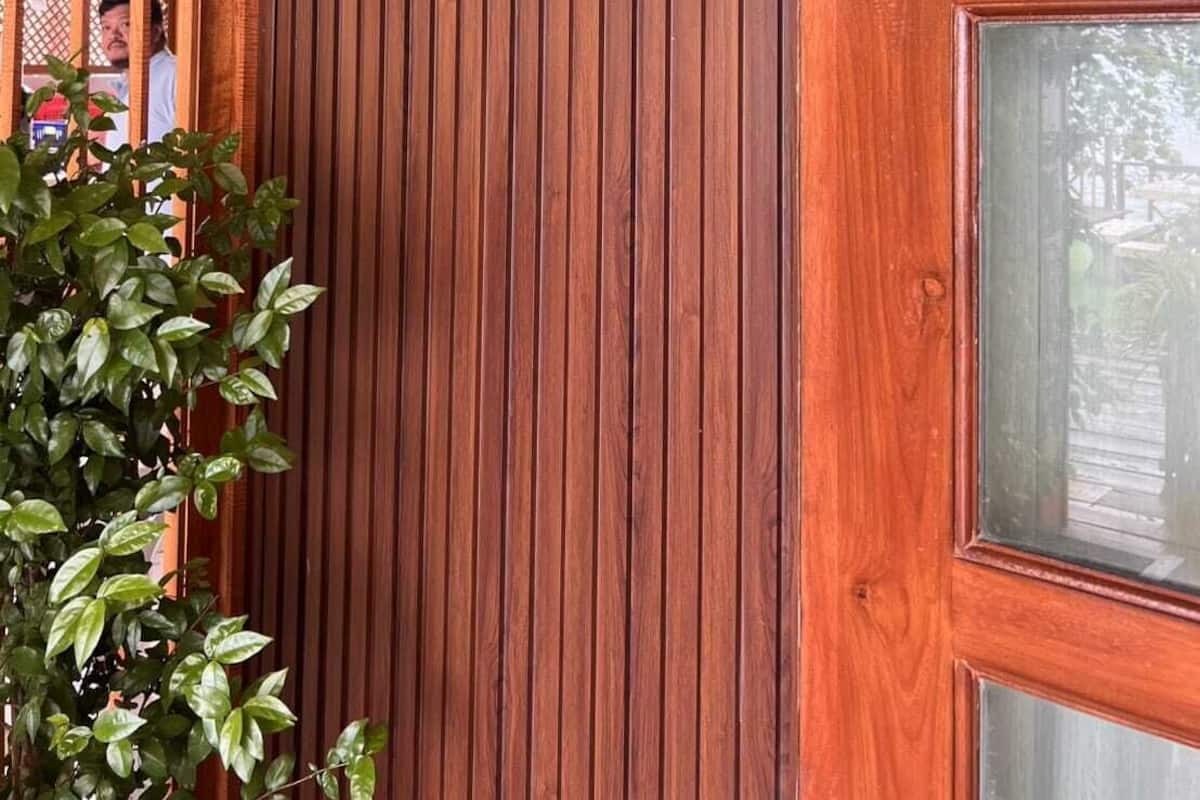 A wooden wall with a vertical panel design and a sign that reads "Slow Life B1".