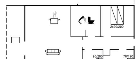A floor plan with a private area, a kitchenette, a bathroom, and a seating area.