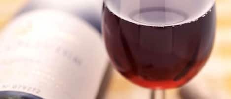 A wine bottle and a glass of red wine.
