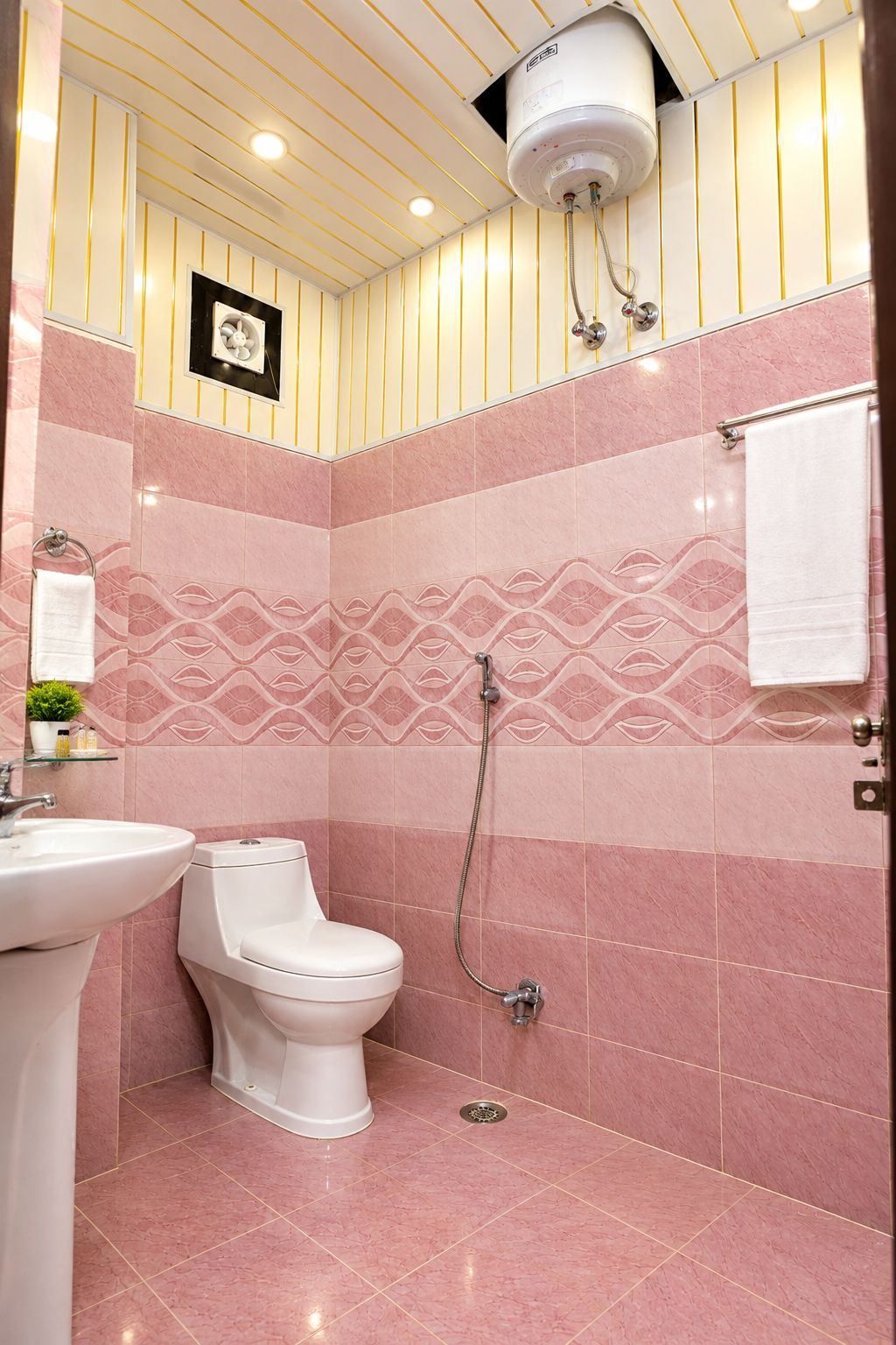 A bathroom with a toilet, sink, and shower.