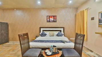 Deluxe Room | Living room | 32-inch flat-screen TV with cable channels