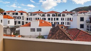 A coastal town with white buildings and red-tiled roofs. - GuestReady - Machico Apartment with Balcony (Machico)