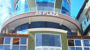 A building with a sign reading 'BLUE TOP MOTEL AS PLAZA' and multiple ATMs. - Blue top motel mbarara (Mbarara)