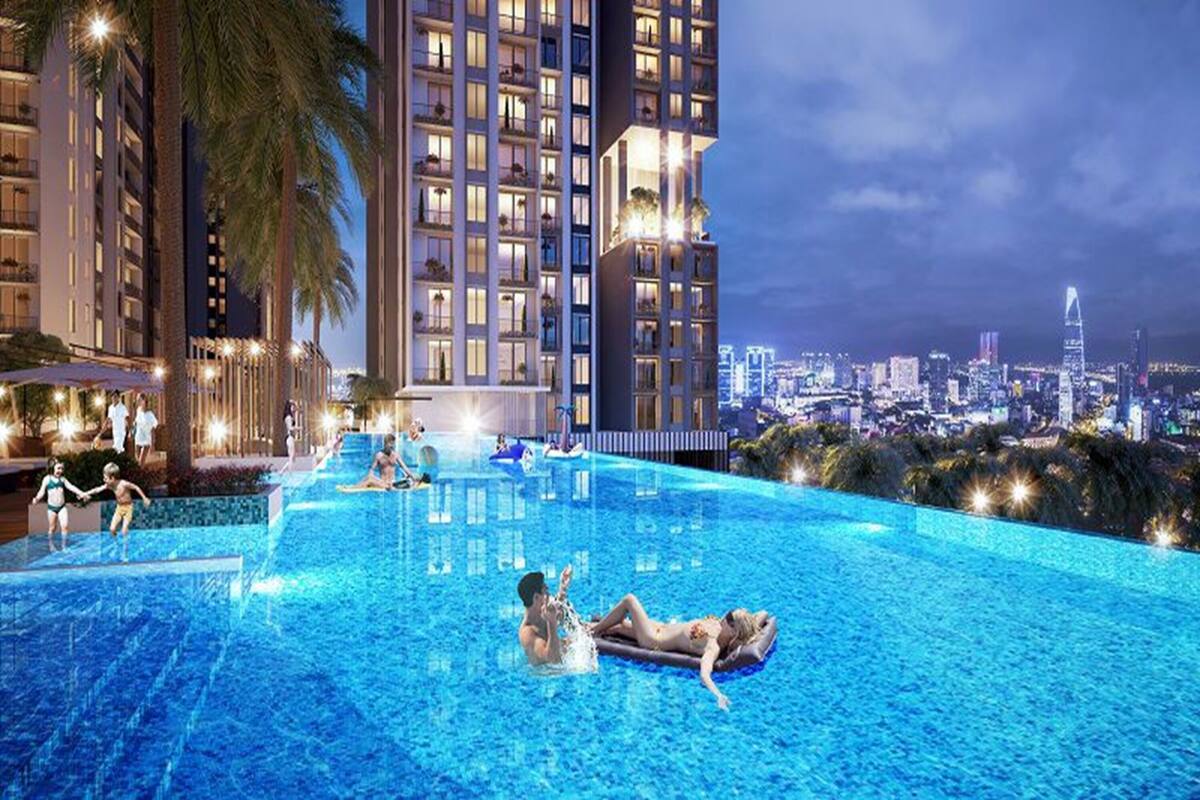 A swimming pool area with people relaxing and swimming, surrounded by tall buildings and palm trees.