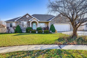 A single-story house with a stone facade, a front porch, and a garage. - 3,500-Sq-Ft Holiday Gem w/ Game Room in Heber City (Heber City)