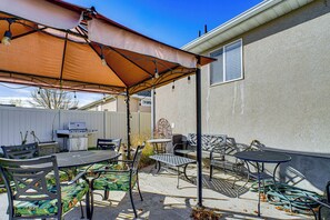 A patio with a grill, outdoor furniture, and a covered area. - 3,500-Sq-Ft Holiday Gem w/ Game Room in Heber City (Heber City)