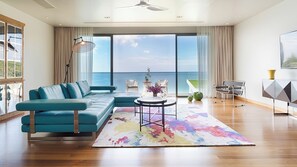 A modern living room with a teal sofa, a round coffee table, and a view of the ocean. - Villa Rodnaya by Elite Havens (A. Thalang)