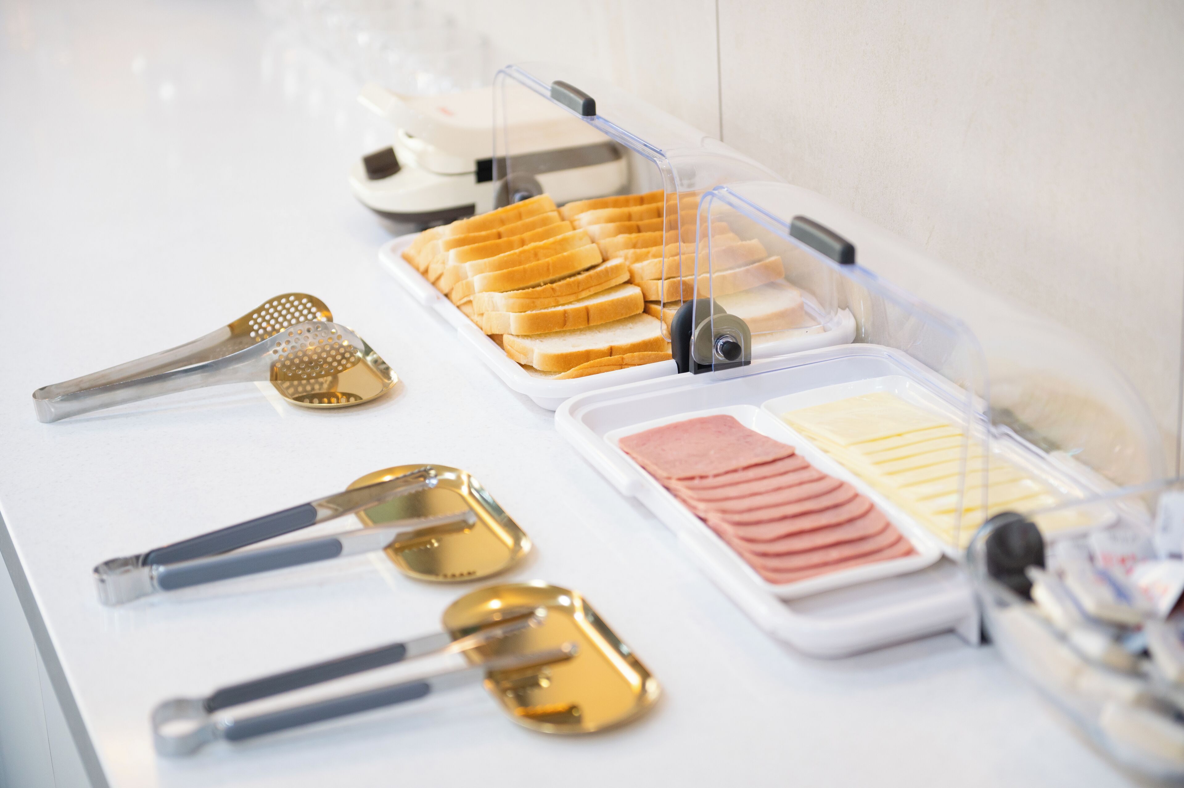 A buffet setup with various food items and utensils.