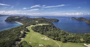 A golf course with a clear view of the surrounding water and islands. - Four Seasons Resort Costa Rica At Peninsula Papaga (Nacascolo)