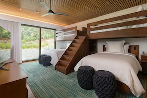 A modern bedroom with a wooden ceiling, bunk beds, a desk, and a view of greenery. - Four Seasons Resort Costa Rica At Peninsula Papaga (Nacascolo)