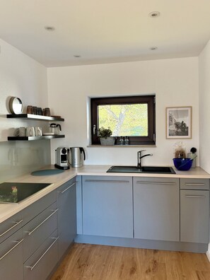 Fridge, stovetop, dishwasher, coffee/tea maker