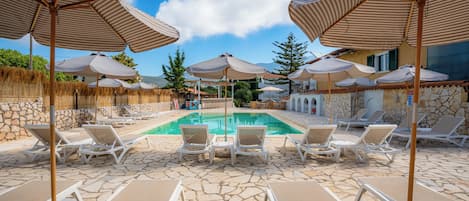 Seasonal outdoor pool, open 10:00 AM to 9:00 PM, pool umbrellas