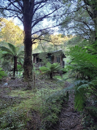 Exterior. Cosie Miners cottage in historic blackball, surrounded by the Paparoa ranges