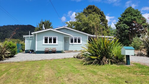 Cosie Miners cottage in historic blackball, surrounded by the Paparoa ranges
