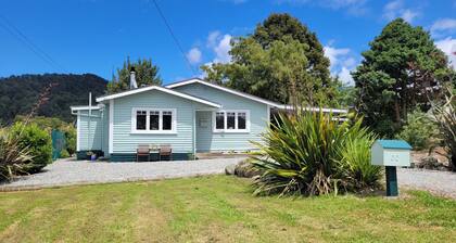 Cosie Miners cottage in historic blackball, surrounded by the Paparoa ranges