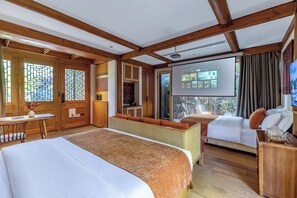 A hotel room with a large bed, a smaller bed, a desk, a projector screen, and a view of the outdoors. - The JOY courtyard Beijing near Tiananmen Forbidden City (Beijing)