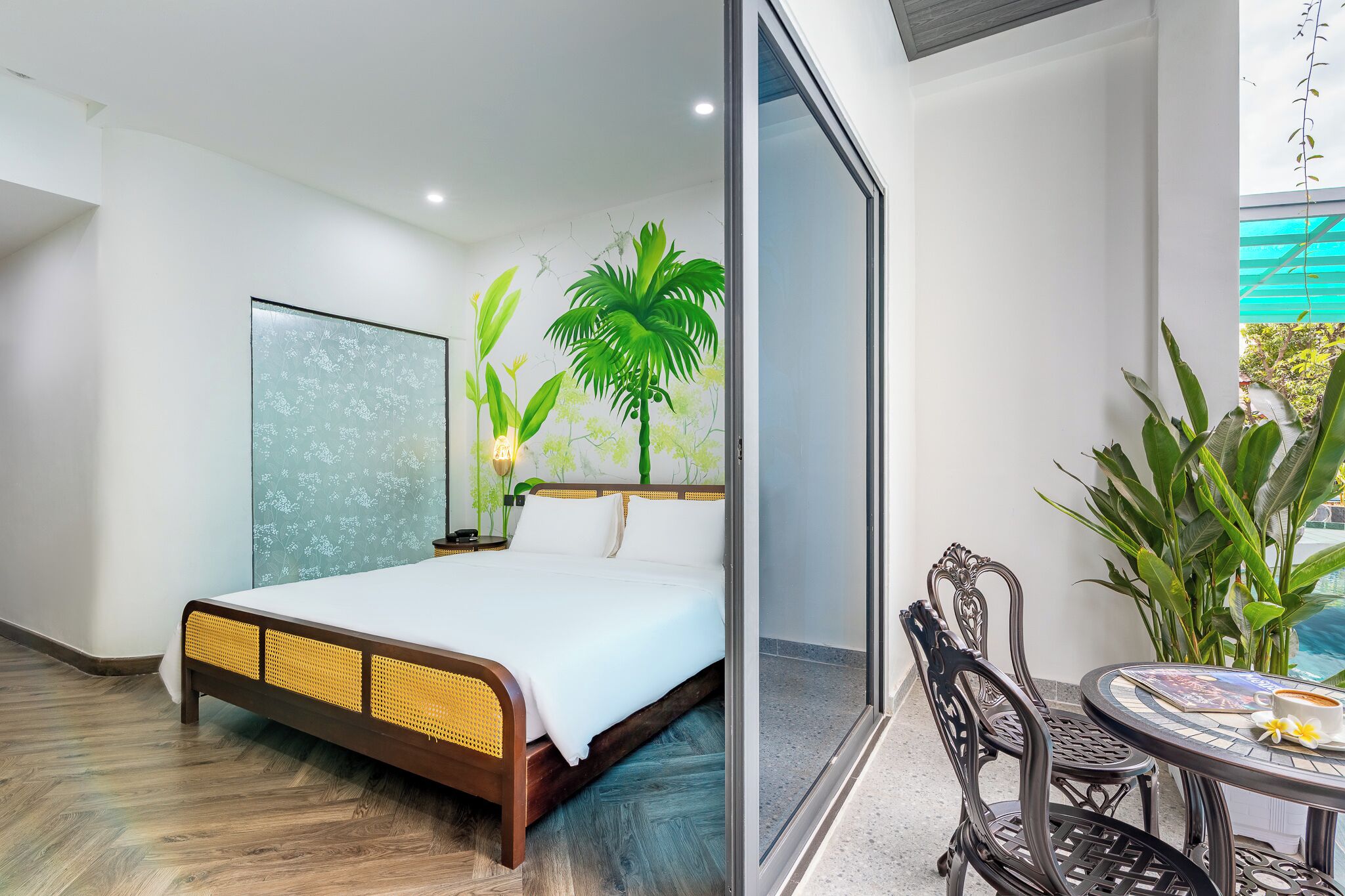 A bedroom with a bed, a nightstand, and a wall mural.