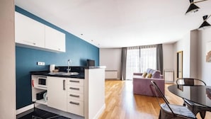 A modern apartment with a kitchen, dining area, and living room. - 1 bedroom apartment with parking in Eixample (Barcelona)