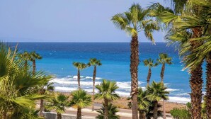 A coastal view with palm trees and the ocean. - Amazing Sea views # Macenas Resort # 2BR # Sunbeds (Mojácar)
