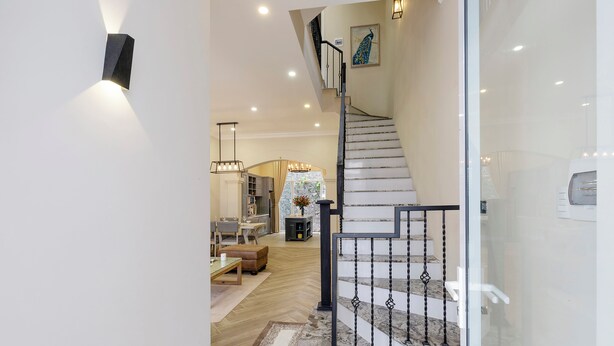 A modern interior with a staircase, a dining area, and a living room. - L'amour Villa with Sauna at City Center (Da Nang)