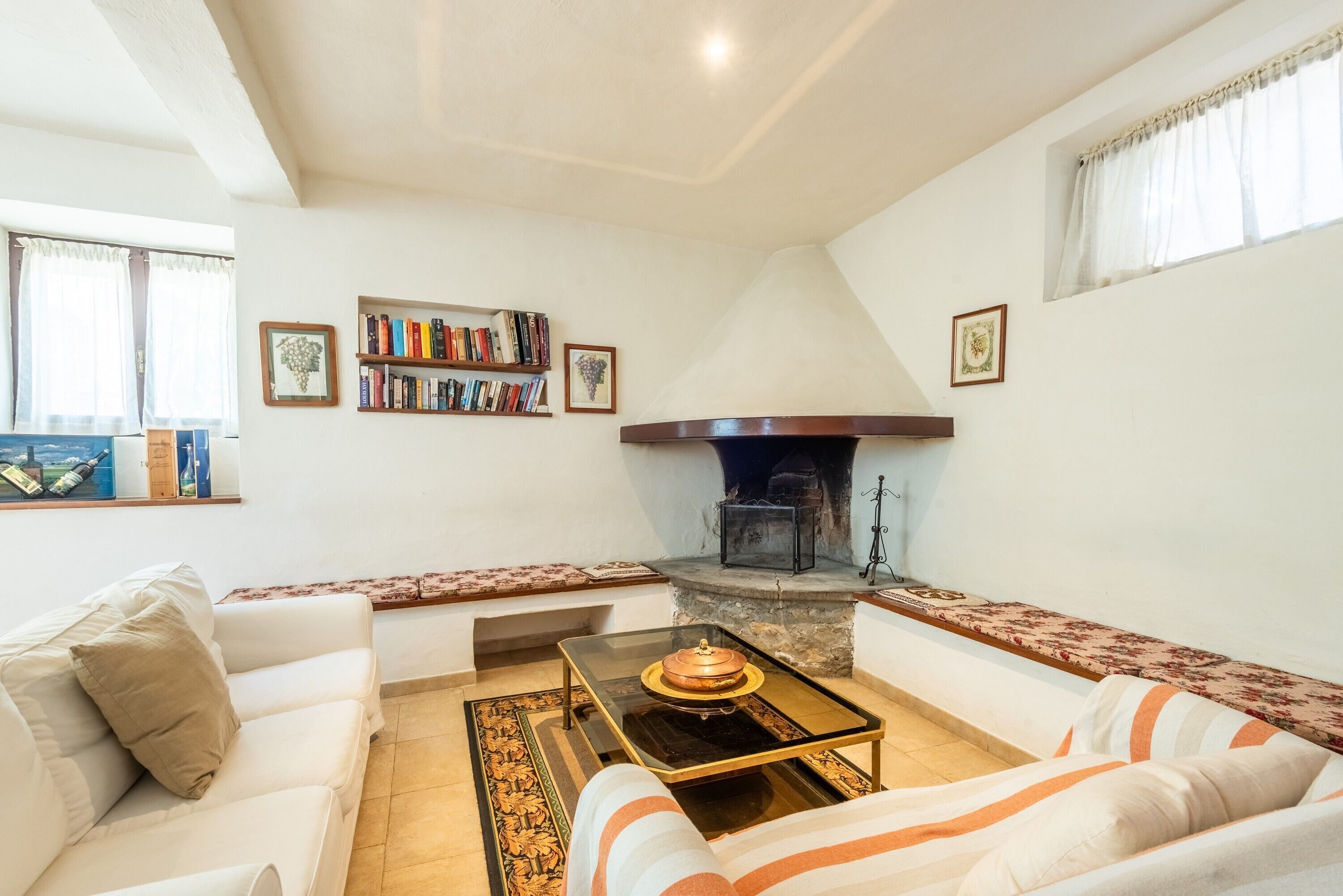 A living room with a fireplace, a sofa, a coffee table, and a bookshelf.