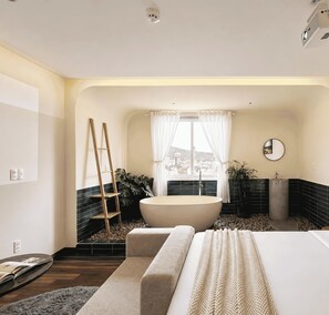 A modern bathroom with a freestanding bathtub, a wooden ladder, a large mirror, and a view of a cityscape through a window. - Joi Boutique Bãi Sau  (Ho Chi Minh City)