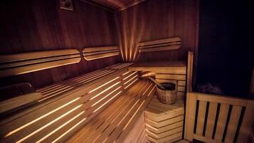 A sauna with wooden benches and benches, a wooden bench with a seat, and a wooden bench with a backrest.