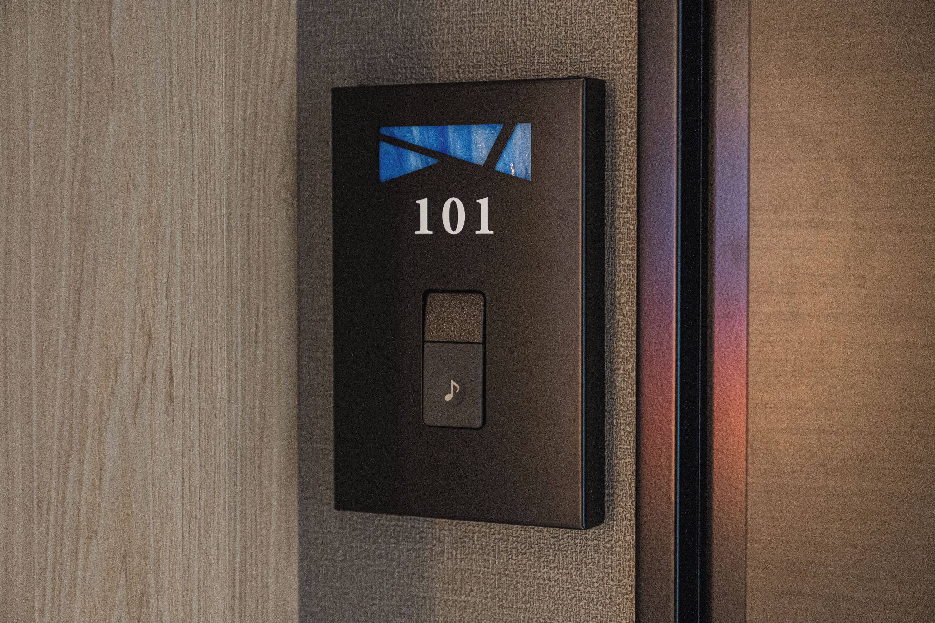 A black elevator control panel with the number 101 and a music note symbol.