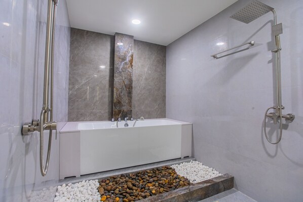 A modern bathroom with a freestanding bathtub, a showerhead, and a marble wall. - Lonuhiri at Dhigurah (Dhigurah)