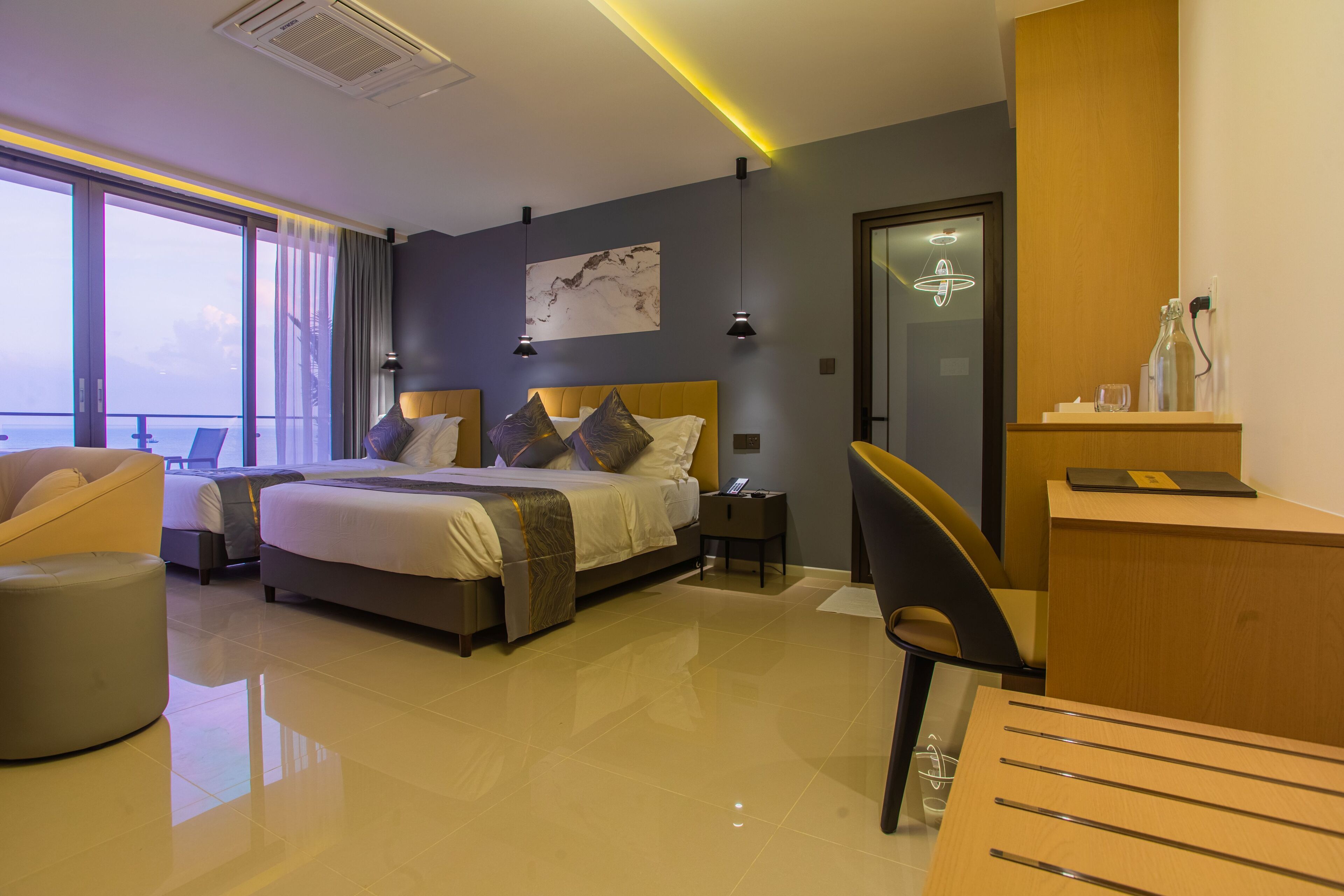 Deluxe Triple Room, Balcony, Sea View | Minibar, in-room safe, desk, laptop workspace