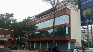 A B.R. Comfort building with a modern design, featuring large glass windows and a brick facade. - BR Comfort (Bengaluru)