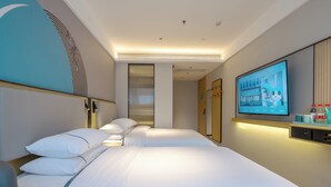 A hotel room with a large bed, a TV, and a mirror. - Home Inn Huayi Select Collection Hotel  (Tongzhou)