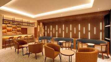 A modern lounge area with seating, a bar, and a decorative wall.