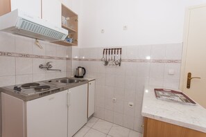 Apartment | Private kitchen | Fridge, microwave, stovetop, electric kettle - Apartments Mastelic - One Bedroom Apartment With Balcony and Sea View Br.1 (Trogir)