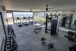 A gym with treadmills, weight machines, and free weights.