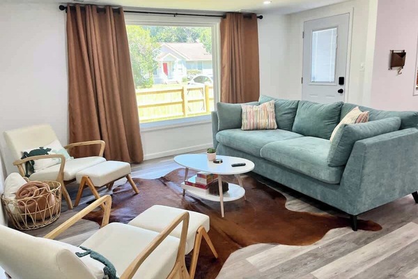 Comfortable pull out sofa, chairs, and a mounted 65 in smart television!