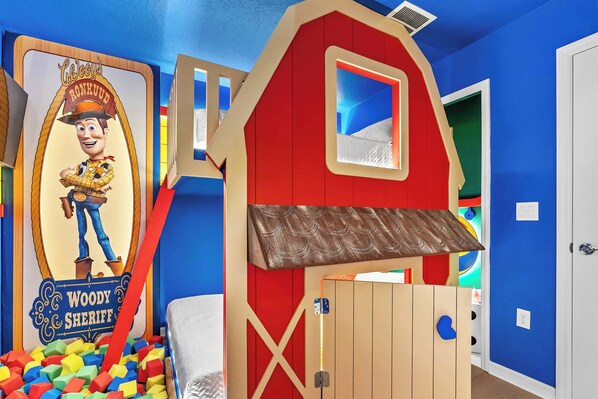 A child's playroom with a Woody the Cowboy theme, including a bed, a playhouse, and a ball pit. - Designer 5BR Gameloft Foam Pit Lazy River 16164 (Clermont)