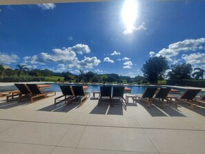 A poolside area with lounge chairs and a clear view of the pool. - Lowlands modern condo with pool and gym access steps away from Mullet Bay Beach (Sint Maarten)