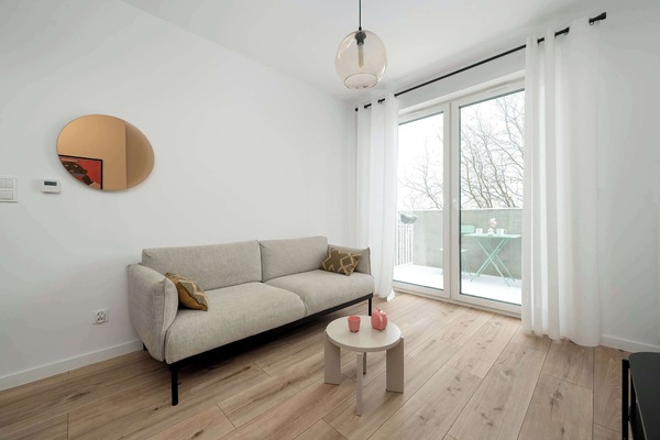 Relax in the stylish living room with a comfortable sofa and modern decor.