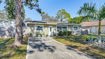 A single-story house with a front yard, a driveway, and a mailbox.