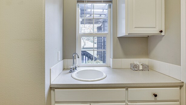 A small bathroom with a window, a sink, and a mirror. - 3 Mi to Dtwn Salem: Cozy Gem w/ Sunroom! (Salem)
