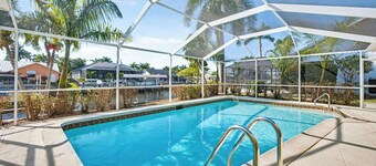 New Listing! Canalfront Comfort | Heated Pool, Patio & Palm-Lined Views