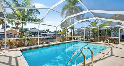 New Listing! Canalfront Comfort | Heated Pool, Patio & Palm-Lined Views