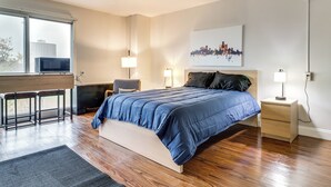 Une chambre moderne avec un grand lit, un bureau et une chaise.